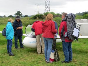 Mike showing people a glider. Most of them thought it was a model.
